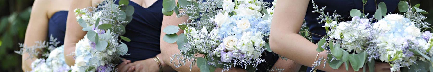 A line of bridesmaides carrying bouquets